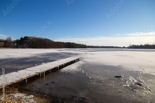 Trakai lake covered with ice in pleasant sunny cold winter day © foxberry
