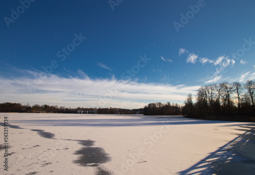 Trakai lake covered with ice in pleasant sunny cold winter day.
