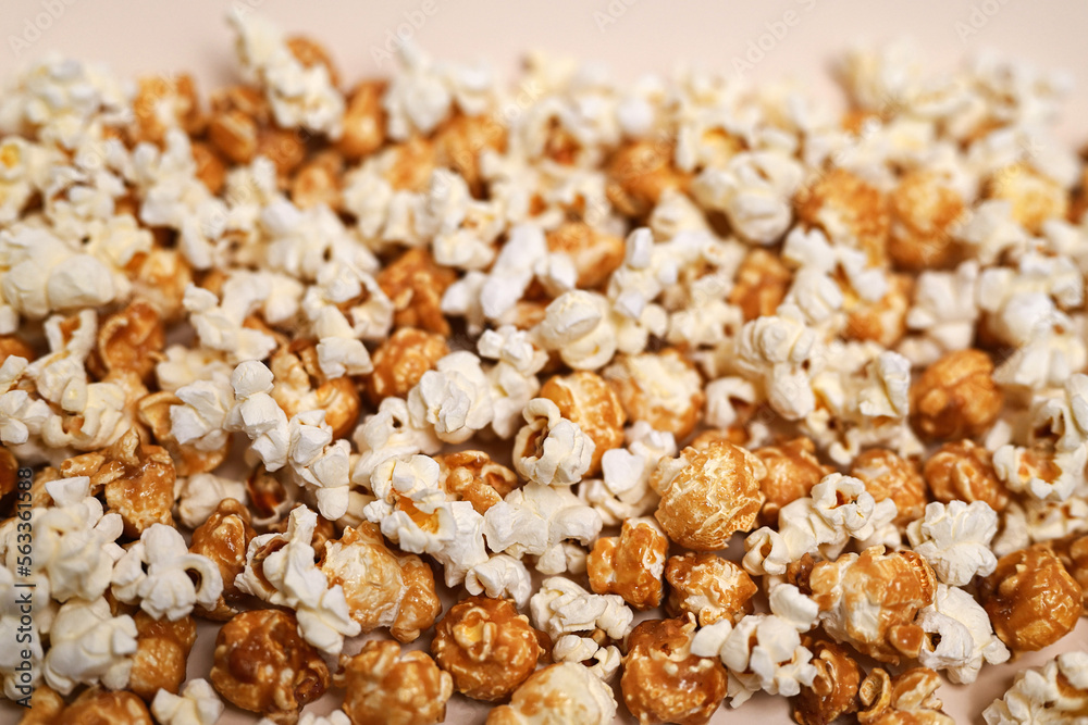 Popcorn background. Caramel popcorn and salted popcorn mixed together. Close-up, shallow depth of field, top view Popcorn background. Caramel popcorn and salted popcorn mixed together. Close-up, shallow depth of field, top view