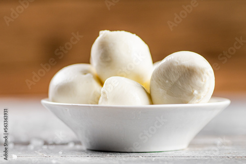 Pieces of mozzarella cheese in a plate on the table.