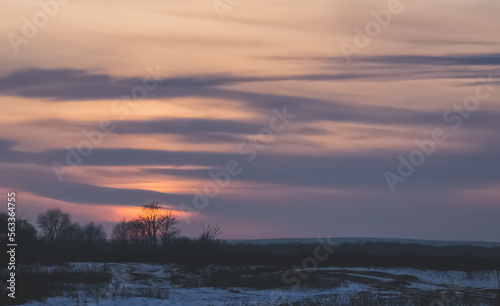 Winter landscape in the evening in the fields of Slobozhanshchina  clouds and the setting sun on the horizon