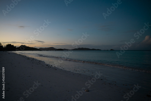 View along the long beach of Anse Volbert in the evening.