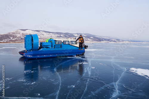 Bilde på lerret A man travels on a hovercraft on transparent ice with cracks in the frozen Lake Baikal