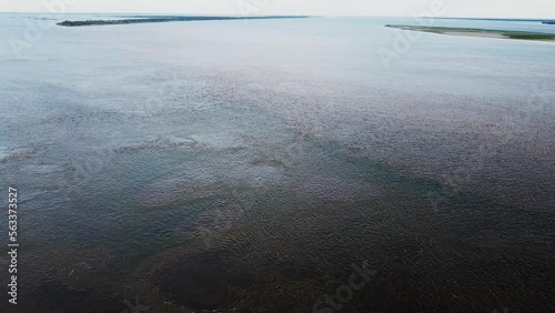 Camera panning down along the Confluence of the Green Blue Rio Tapajos and the Brown Rio Amazon rivers Aerial Video photo