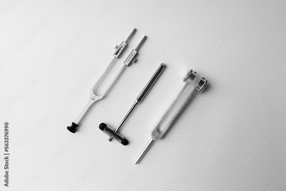 tuning fork C 128 on a white background with gradation and neurological hammer tuning fork C 128 on a white background with gradation and neurological hammer