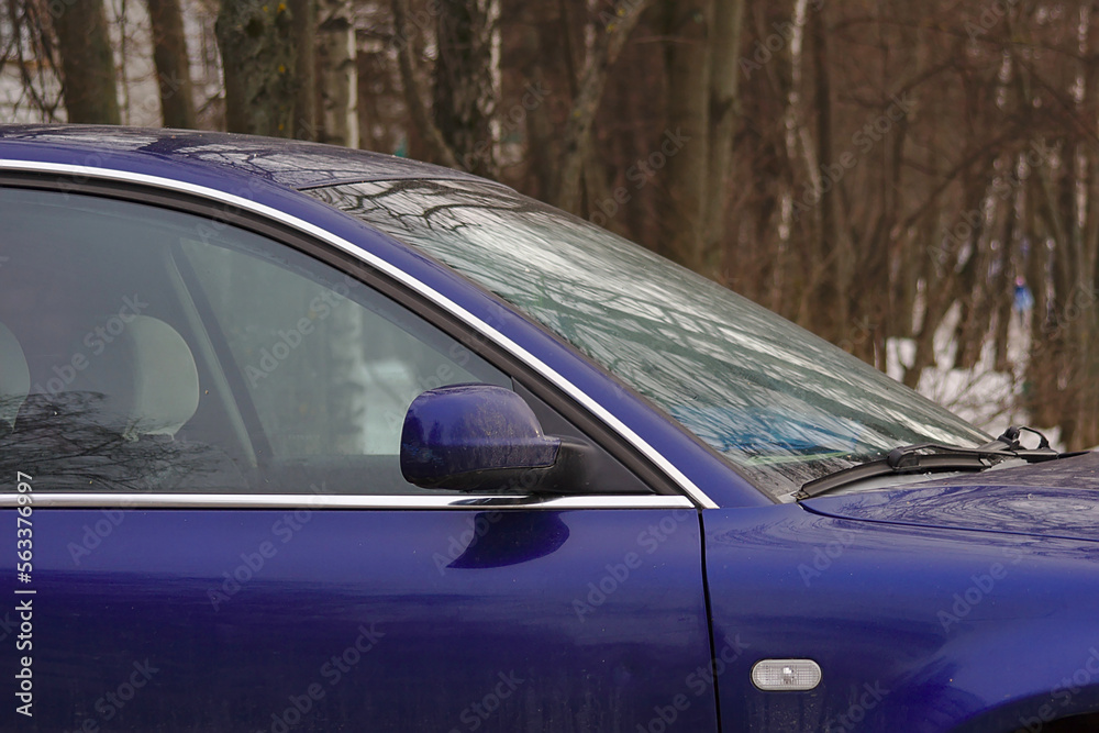 Fragment of a blue car in winter