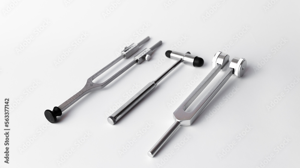 tuning fork C 128 on a white background with gradation and neurological hammer tuning fork C 128 on a white background with gradation and neurological hammer