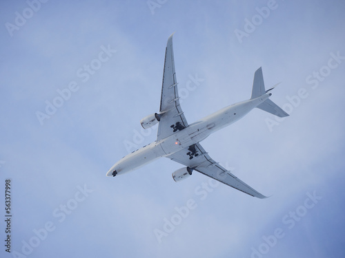 Plane in blue sky  overhead  under plane  landing gear extension  signal fire.