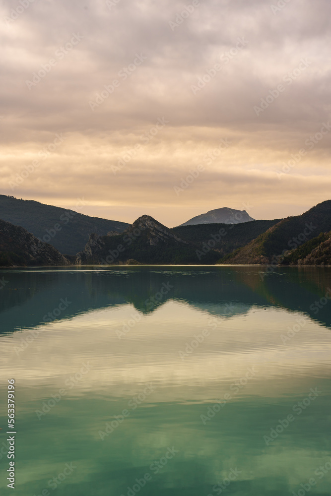 Beautiful valley in France, reflection of the mountains in a peaceful lake.