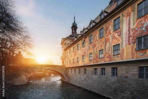 Side view of Old Town Hall (Altes Rathaus) with frescoes and bridge over Regnitz River at sunset - Bamberg, Bavaria, Germany