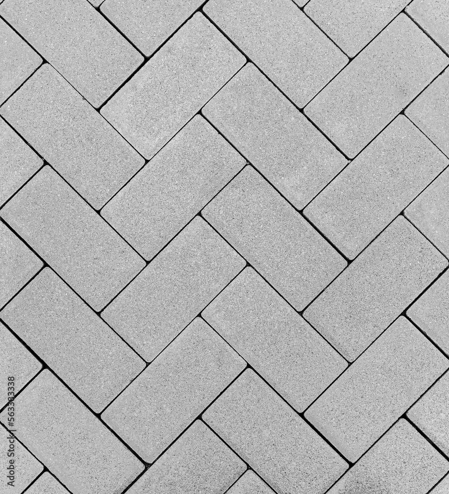 Obraz premium Top view of a gray brick outdoor flooring in a zig zag pattern