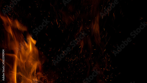 Sparks and fire on a black background. Abstract blurred bonfire with sparks and flames.