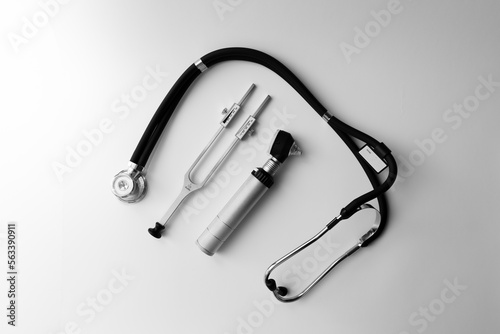 tuning fork C 128 on a white background with gradation, otorhinoscope and stethoscope
