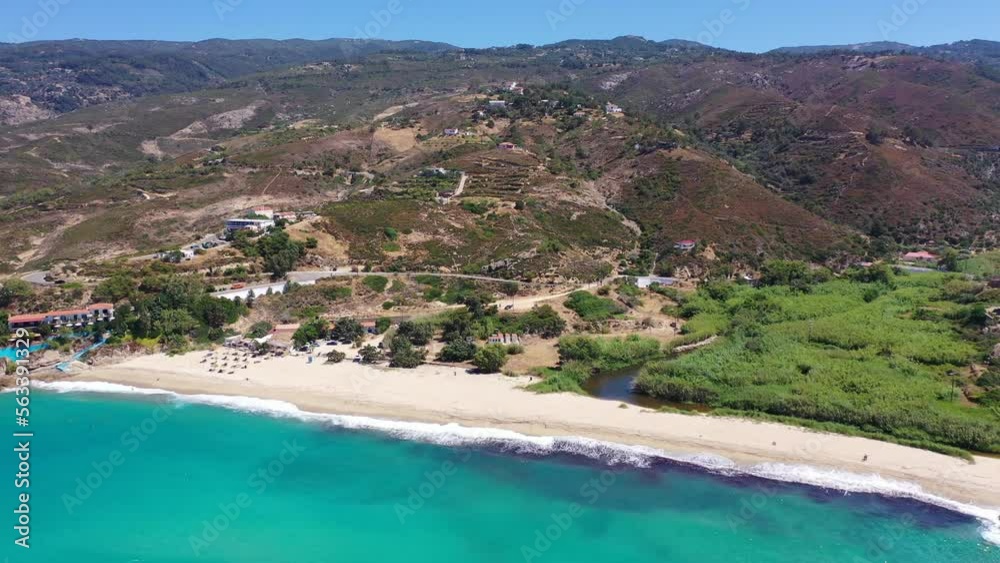 Aerial drone video of famous bay and organised sandy beach of Livadi Armenistis, popular for surfing sports, Ikaria island, Northeast Aegean, Greece Aerial drone video of famous bay and organised sandy beach of Livadi Armenistis, popular for surfing sports, Ikaria island, Northeast Aegean, Greece