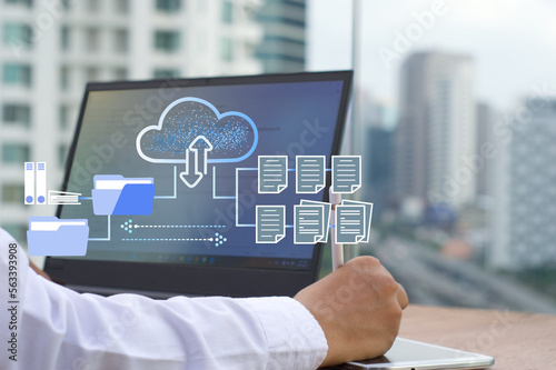 businessman  working on a laptop using FTP (File Transfer Protocol) with a paperless system