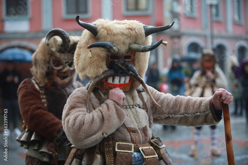 Breznik, Bulgaria - January 21, 2023: Unidentified people with traditional Kukeri costume are seen at the Festival of the Masquerade Games Surova in Breznik, Bulgaria photo