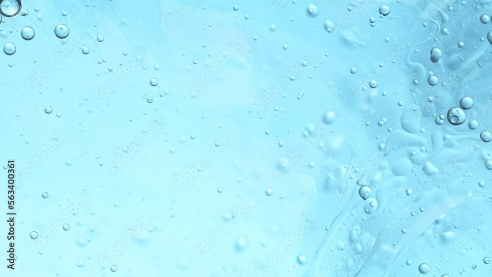 Super Slow Motion Shot of Oil Bubbles Moving in Water on Light Blue Gradient Background at 1000fps. Super Slow Motion Shot of Oil Bubbles Moving in Water on Light Blue Gradient Background at 1000fps.