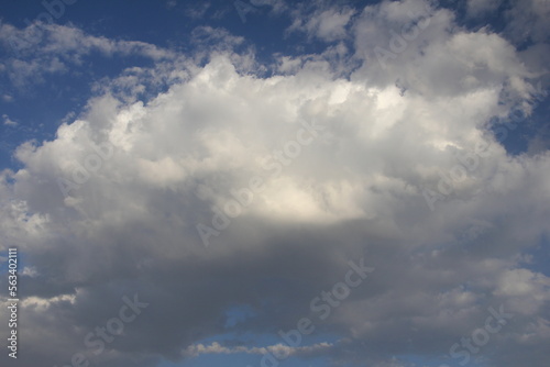 Blue sky with clouds. White big cloud in the sky. Clouds in the background. © Loucine