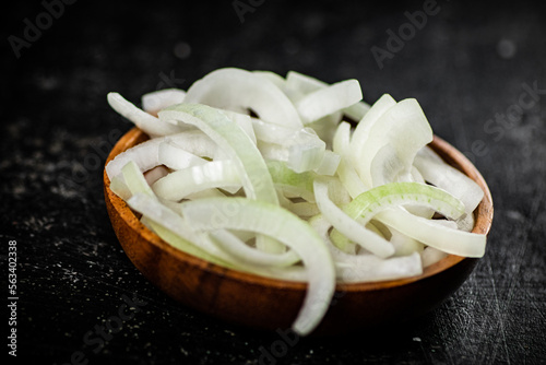 Chopped onions in a wooden plate. 