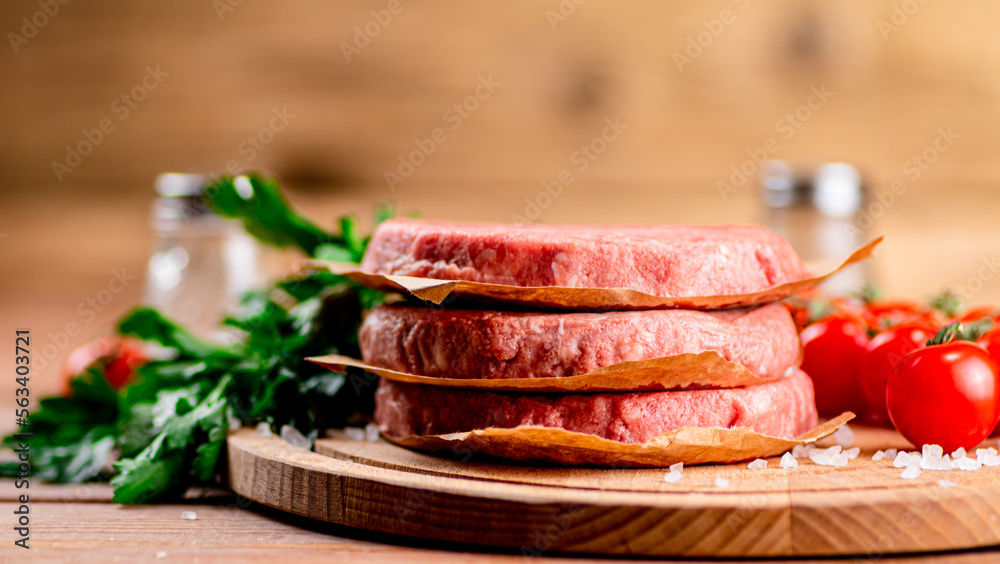Raw burger with fresh tomatoes. Raw burger with fresh tomatoes.
