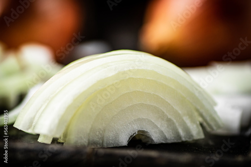 Pieces of onions on a cutting board. 