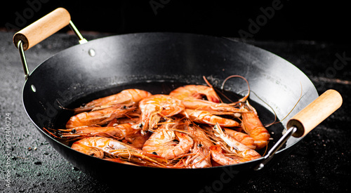 Saucepan with cooked boiled shrimp. 
