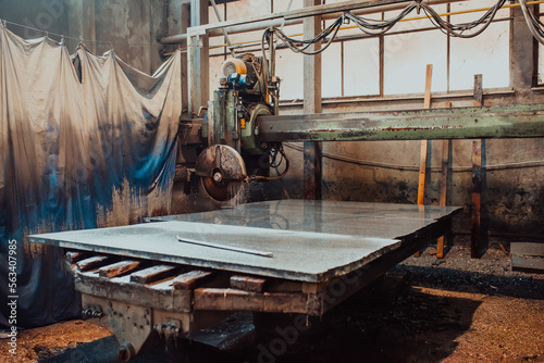 A stone cutter processes stone and granite slabs in the industry