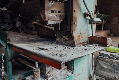 Wallpaper Mural A worker in heavy industry breaks stone blocks using large machines. Granite and stone processing industry. Torontodigital.ca
