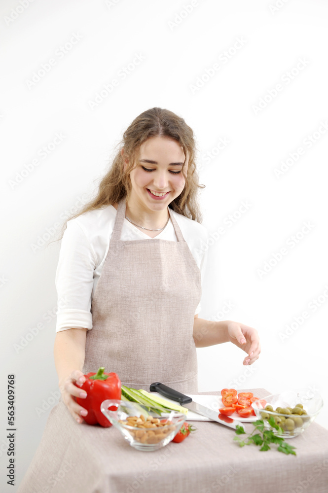 Smiling young woman serving fresh salad on plate. Happy smiling cute woman cooking fresh healthy vegan salad at home with many vegetables in kitchen and trying new recipe High quality photo Smiling young woman serving fresh salad on plate. Happy smiling cute woman cooking fresh healthy vegan salad at home with many vegetables in kitchen and trying new recipe High quality photo