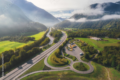 Aerial view of natural landscapes and highway asphalt road along lakes and mountains