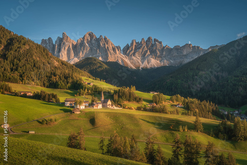 Dolomite mountain landscapes, beautiful small village in Val di Funes, with church and mountains in Dolomite Alps, Italy
