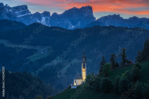 Small church in the mountain at sunset and night, Chiesa di Santa Barbara in Dolomite Alps, Italy