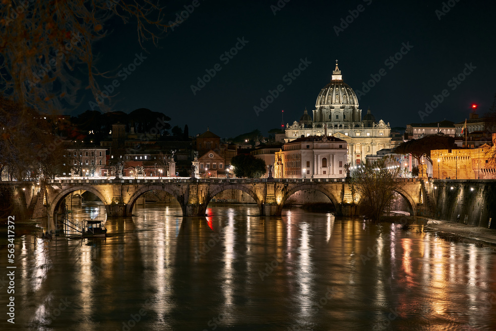 Ponte Sant'Angelo and St Peter Basilica at night in Rome, Italy