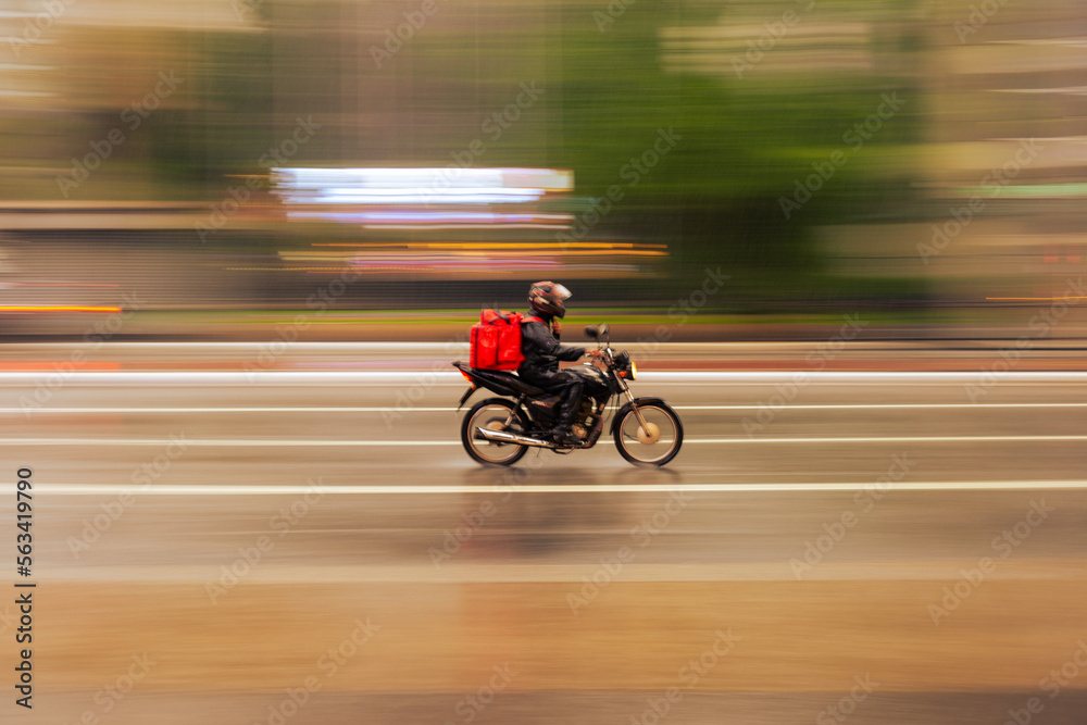 Food delivery boy riding a bike in the city