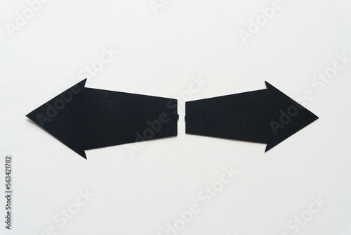 two black paper arrows pointing in opposite directions