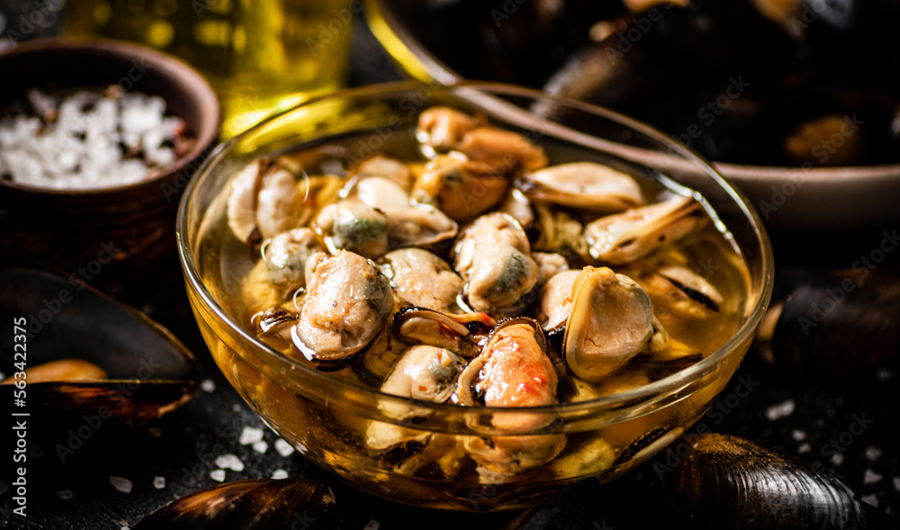 Pickled mussels in a glass bowl with spices. Pickled mussels in a glass bowl with spices.