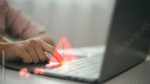 Computer notification error maintenance concept. programmer, or developer using a computer laptop with a triangle warning exclamation red sign trouble caution.