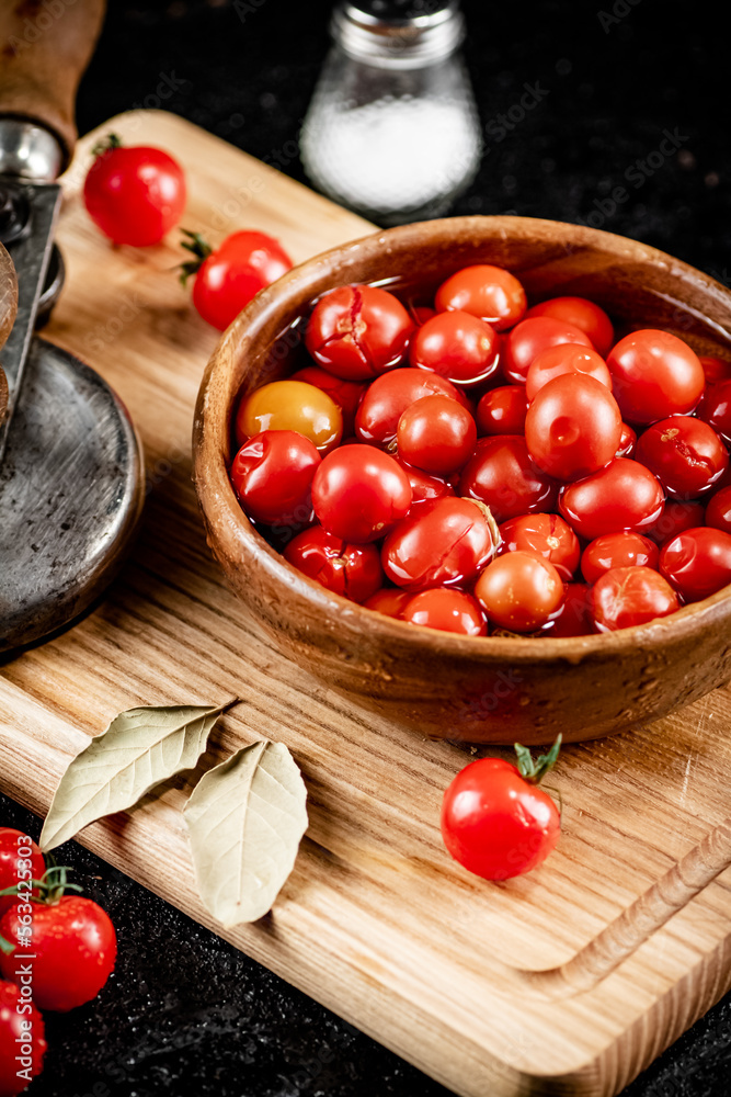Pickling ripe tomatoes on a cutting board. Pickling ripe tomatoes on a cutting board.