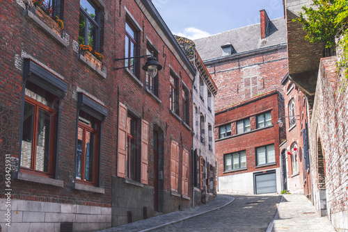 Obraz na płótnie Old town of Mons with red brick houses along the street w salonie