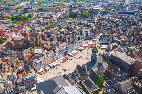 Obraz na płótnie Aerial summer view of vibrant central square (Grand-Place de Mons) and old town hall of Mons (Bergen). Wallonia, capital of Hainaut, Belgium. w salonie
