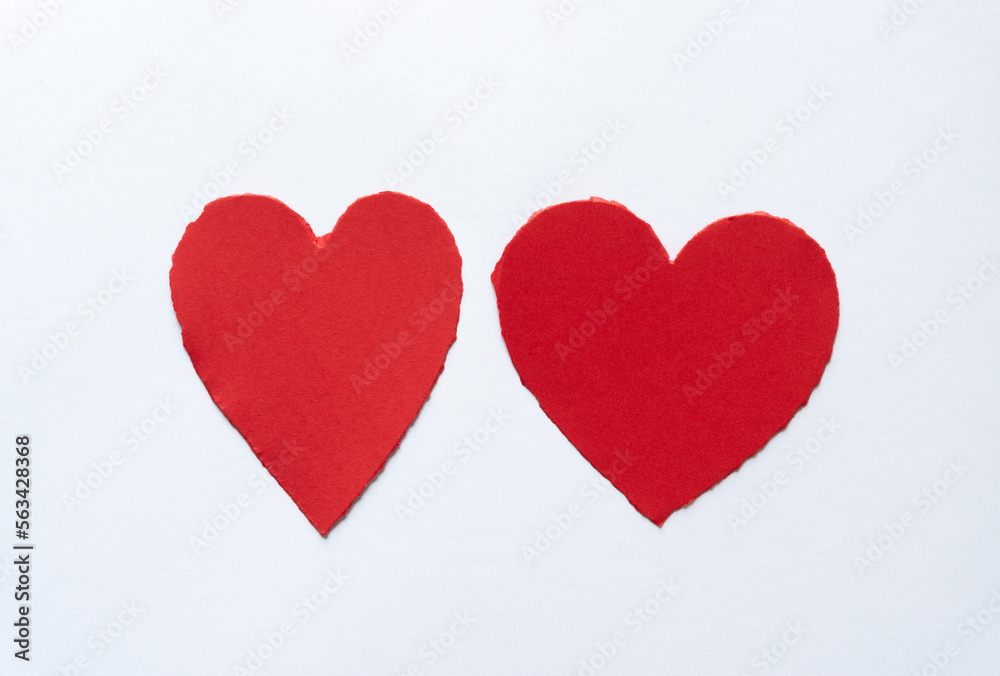 two hearts with torn edges on a white background
