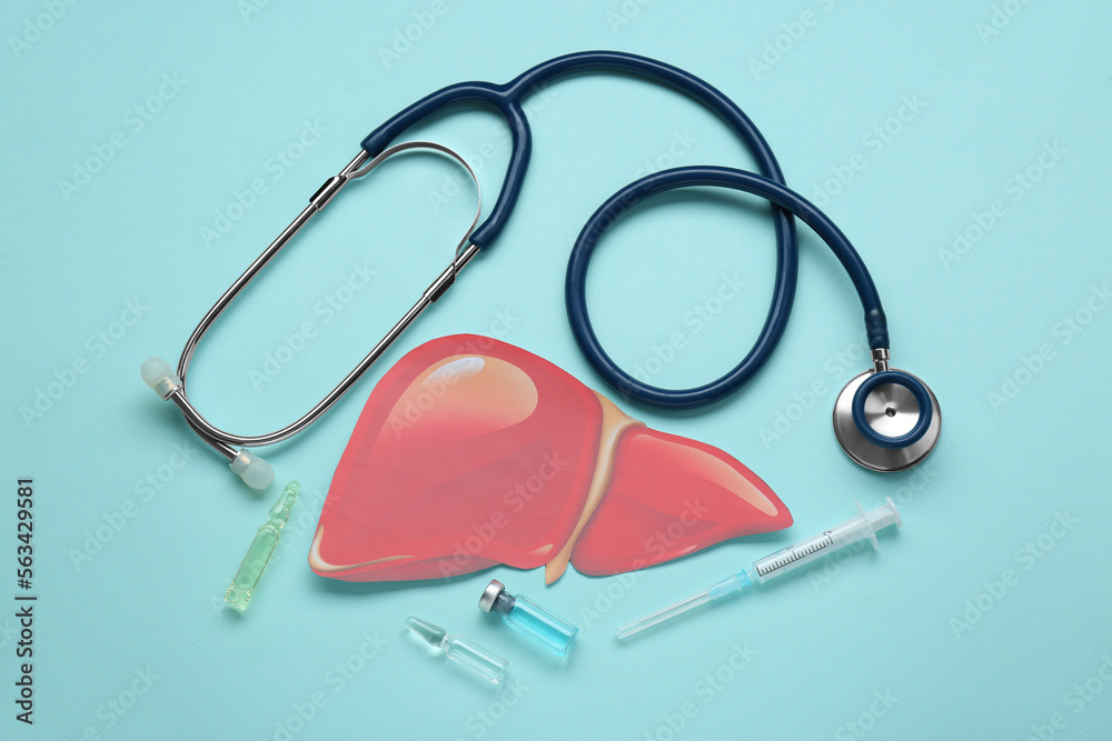 Paper liver, stethoscope, syringe and vials on turquoise background, flat lay. Hepatitis treatment