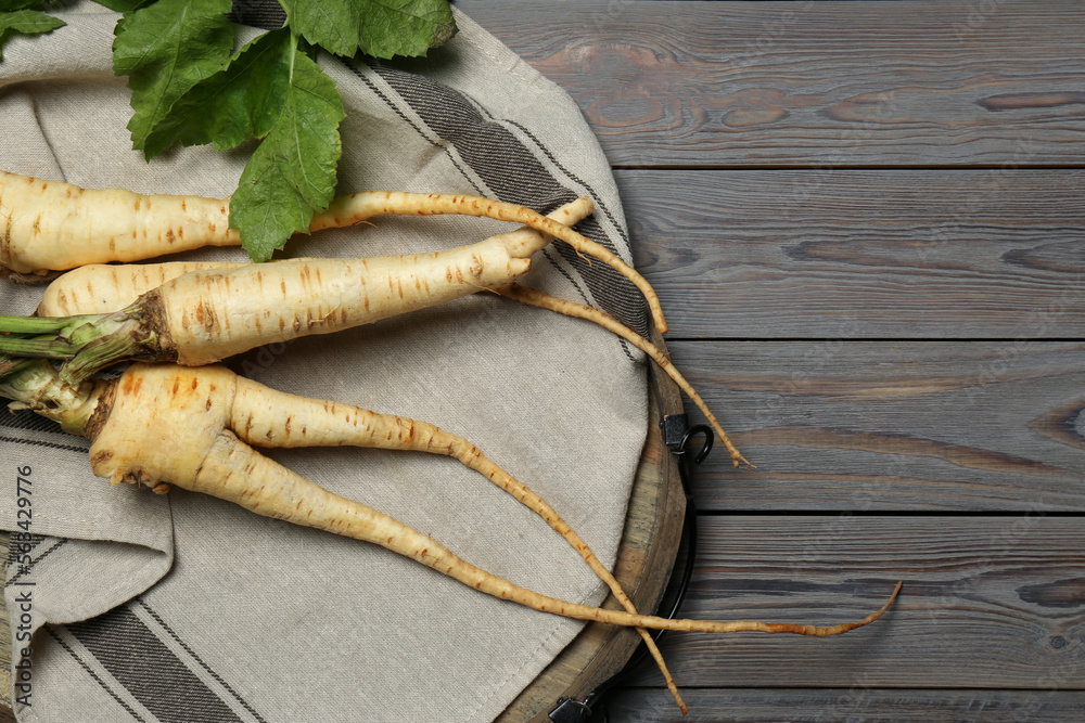 Tasty fresh ripe parsnips on grey wooden table, top view. Space for text Tasty fresh ripe parsnips on grey wooden table, top view. Space for text