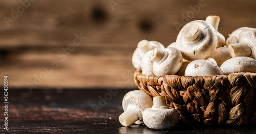A full basket of mushrooms on the table.