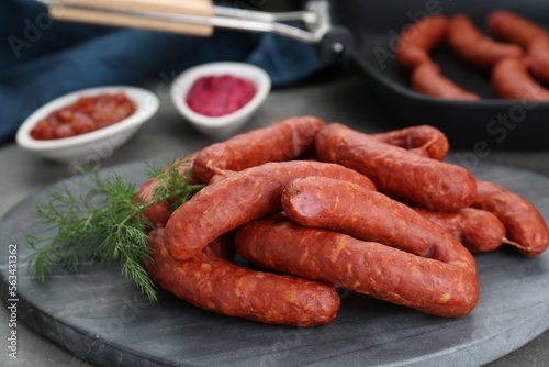 Delicious sausages and dill on grey table