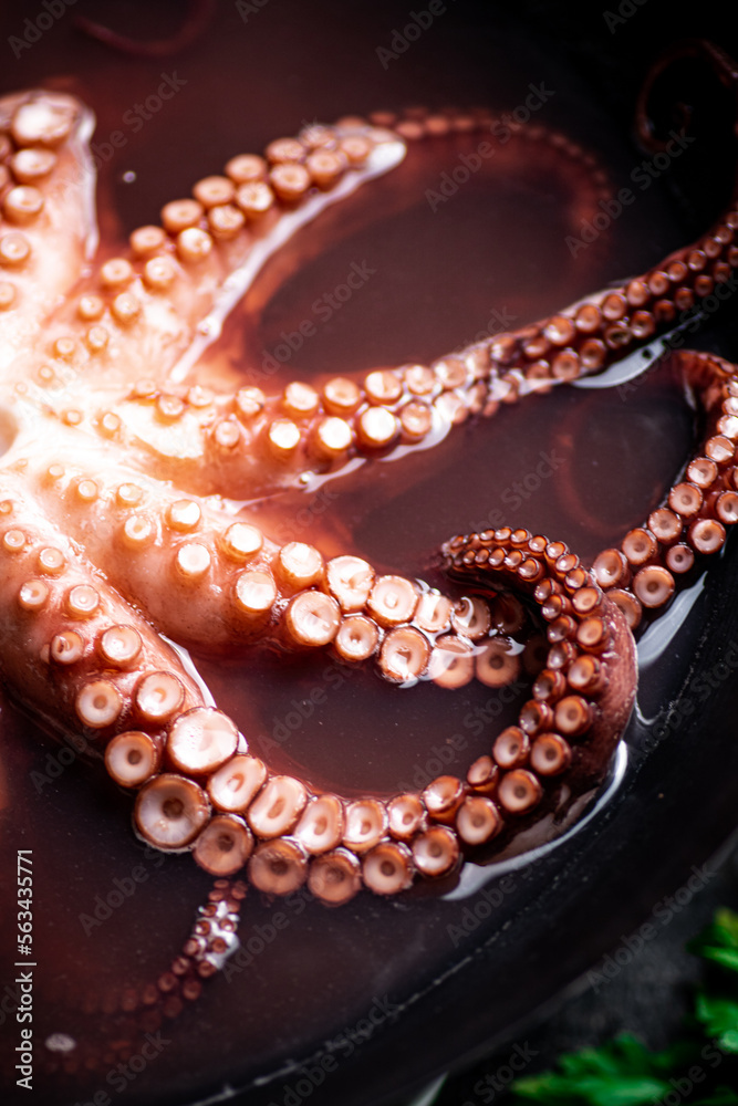 Octopus is boiled in a pot of water. 