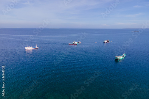 Beautiful aerial view of Kelapa Lima Beach with many traditional boats, a tropical beach and coastline located in Kupang, East Nusa Tenggara, Indonesia. 