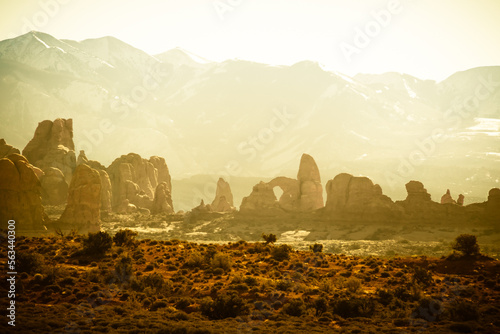 Photographie Rock formations with distant snow-covered mountains in the distance in Arches National Park