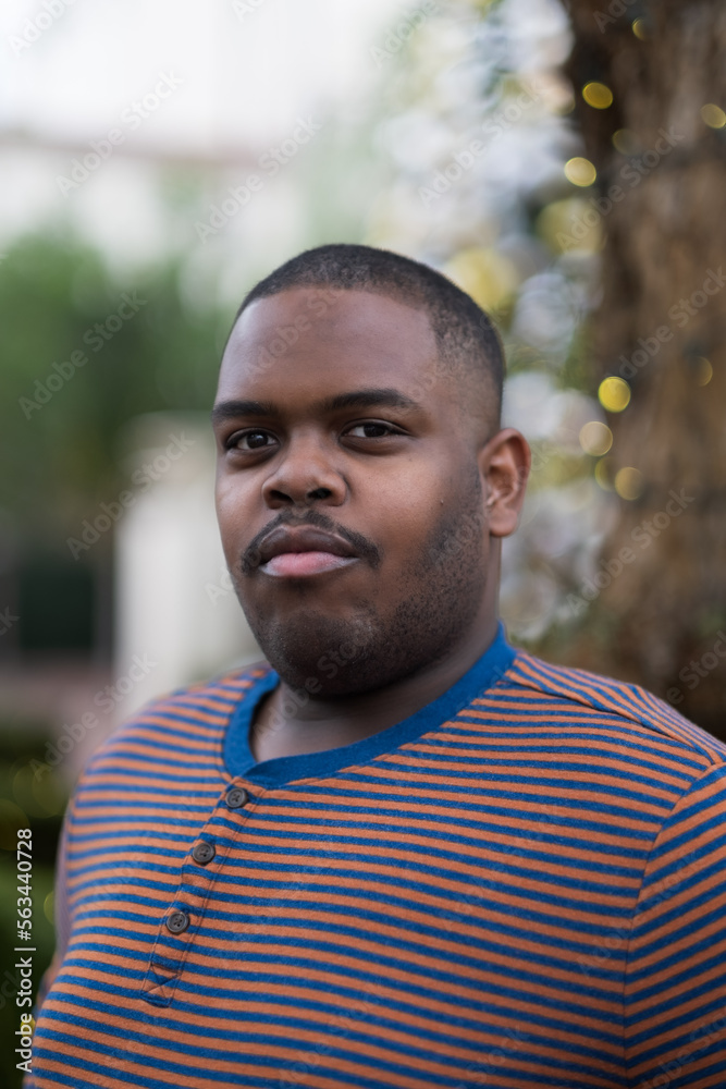 In an outdoor public space, a young African American man expresses confidence In an outdoor public space, a young African American man expresses confidence
