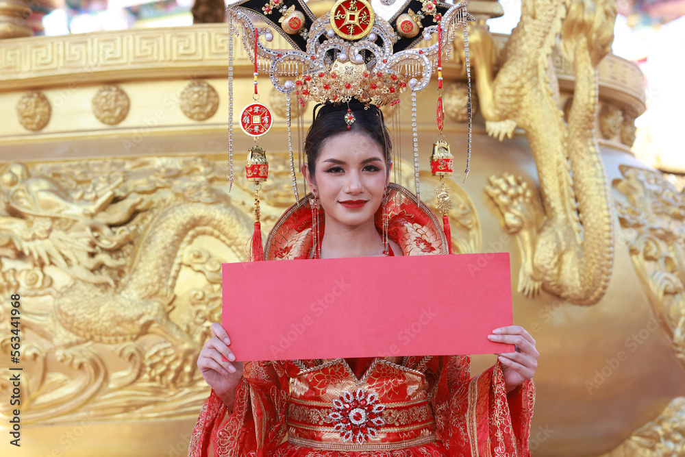 Chinese new year , Portrait young asian woman with  traditional red Chinese hong hao cheongsam qipao costume, Beautiful woman wearing red qipao hold red empty banner on Chinese new year